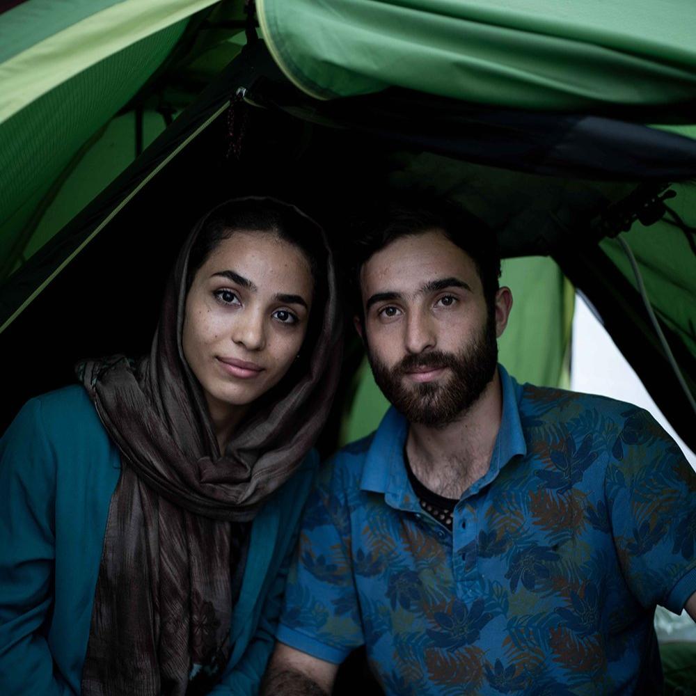 Young refugee couple in a tent.