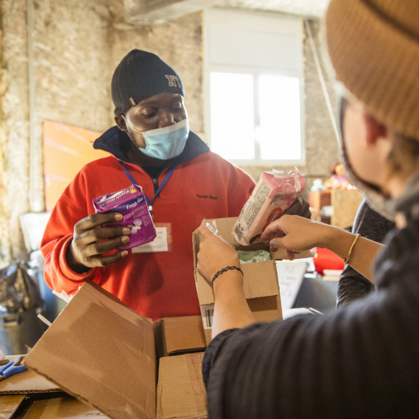 Volunteers putting together washing essentials packs for refugees.